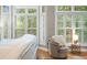 Comfortable main bedroom features floor to ceiling windows with plantation shutters and wood flooring at 1500 Trumpet Vine Ct, Mount Pleasant, SC 29464
