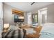 Bright main bedroom with a large window, TV, hardwood floors, and seating area at 1500 Trumpet Vine Ct, Mount Pleasant, SC 29464