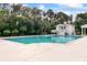 Community pool with white pool house, palm trees and comfortable lounge chairs at 1500 Trumpet Vine Ct, Mount Pleasant, SC 29464