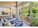 Relaxing sunroom with a cozy seating area, modern fire pit, and picturesque views of lush greenery at 1500 Trumpet Vine Ct, Mount Pleasant, SC 29464