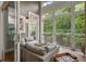 Inviting sunroom with comfortable seating, a view of nature, and screened windows with an exterior door at 1500 Trumpet Vine Ct, Mount Pleasant, SC 29464
