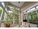 Bright sunroom with comfortable seating, potted palm, and view to trees at 1500 Trumpet Vine Ct, Mount Pleasant, SC 29464