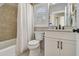 Well-lit bathroom featuring a tiled shower, toilet, vanity with a mirror, and white cabinets at 1500 Trumpet Vine Ct, Mount Pleasant, SC 29464