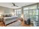 Comfortable bedroom featuring a large window, ceiling fan, and hardwood floors at 1500 Trumpet Vine Ct, Mount Pleasant, SC 29464