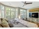 Well-lit primary bedroom featuring large windows, a ceiling fan, and hardwood floors at 1500 Trumpet Vine Ct, Mount Pleasant, SC 29464