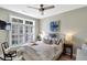 Cozy bedroom with a white bed frame, shuttered windows, and wood flooring at 1500 Trumpet Vine Ct, Mount Pleasant, SC 29464