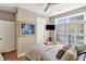Bright bedroom with large windows, plantation shutters, a television, and a tray on the bed at 1500 Trumpet Vine Ct, Mount Pleasant, SC 29464