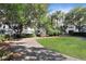 Courtyard featuring gravel path, bench, and manicured green space near homes at 1500 Trumpet Vine Ct, Mount Pleasant, SC 29464