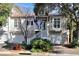 Charming two-story townhouse with a well-maintained yard, white picket fence, and an inviting entryway at 1500 Trumpet Vine Ct, Mount Pleasant, SC 29464