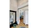 Bright foyer featuring hardwood floors, neutral walls, a large mirror, and a glimpse into the living area at 1500 Trumpet Vine Ct, Mount Pleasant, SC 29464