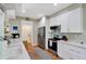 Bright kitchen with white cabinets, stainless steel appliances, and hardwood floors at 1500 Trumpet Vine Ct, Mount Pleasant, SC 29464