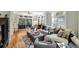 Cozy living room with hardwood floors, neutral walls, large windows, comfortable seating, and access to the outdoor patio at 1500 Trumpet Vine Ct, Mount Pleasant, SC 29464