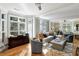 Bright living room with hardwood floors, neutral walls, large windows, and stylish furniture creates a welcoming space at 1500 Trumpet Vine Ct, Mount Pleasant, SC 29464