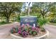 Community entrance sign with manicured landscaping and colorful flowers at 1500 Trumpet Vine Ct, Mount Pleasant, SC 29464