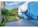 Backyard featuring a lush green lawn, plants, and an exterior staircase at 154 Wentworth St, Charleston, SC 29401