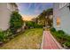 Backyard featuring a lush green lawn and a charming brick pathway at 154 Wentworth St, Charleston, SC 29401