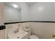 Compact bathroom with white tiled walls, dark trim, and a white sink and toilet at 154 Wentworth St, Charleston, SC 29401
