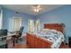 Blue bedroom with wood bed, ceiling fan, and desk with chair at 154 Wentworth St, Charleston, SC 29401
