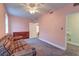 Neutral carpeted bedroom with ceiling fan, light pink walls, and a dresser with ample closet space at 154 Wentworth St, Charleston, SC 29401