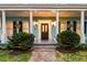Inviting entrance showcasing brick pathway, well-manicured landscaping and a stylish black door at 154 Wentworth St, Charleston, SC 29401