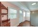 Cozy light-filled entryway with hardwood floors, large windows, and stainless steel refrigerator at 154 Wentworth St, Charleston, SC 29401