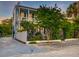 Charming two-story light blue home with a balcony, mature trees, and an iron gate for added curb appeal at 154 Wentworth St, Charleston, SC 29401