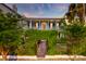 Elegant two-story home with a covered balcony, vine-covered gate, and manicured landscaping for curb appeal at 154 Wentworth St, Charleston, SC 29401