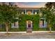 Home with wrought iron gate and vine covered archway at 154 Wentworth St, Charleston, SC 29401