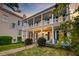 Charming two-story home featuring a spacious porch with columns, manicured landscaping and blossoming flowers at 154 Wentworth St, Charleston, SC 29401