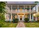 Charming two-story home featuring a spacious porch with columns and manicured landscaping at 154 Wentworth St, Charleston, SC 29401