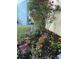 Well-manicured flower garden with various colors blooming in a mulched bed along the exterior wall at 154 Wentworth St, Charleston, SC 29401