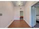 Elegant foyer with hardwood floors, chandelier, and neutral paint, offering a view to other rooms at 154 Wentworth St, Charleston, SC 29401