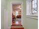 View through the arched doorway reveals a hardwood floor and comfortable space at 154 Wentworth St, Charleston, SC 29401