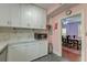 Bright kitchen with appliances, light countertops and cabinetry, and access to dining room at 154 Wentworth St, Charleston, SC 29401