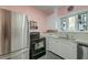 Functional kitchen with stainless steel appliances and a unique stained glass window at 154 Wentworth St, Charleston, SC 29401