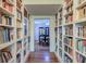 Library space with floor-to-ceiling bookcases, hardwood floors, and view into dining room at 154 Wentworth St, Charleston, SC 29401