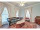 Bright and airy living room with period furniture, a decorative rug, and lots of natural light at 154 Wentworth St, Charleston, SC 29401