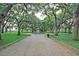 Park view featuring a gravel path, statue, large trees, and green grass at 154 Wentworth St, Charleston, SC 29401