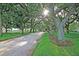 Park view featuring a gravel path, statue, large trees, and green grass at 154 Wentworth St, Charleston, SC 29401