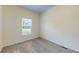 Well-lit bedroom showing neutral walls, plush carpet, and a window with great natural light at 1576 Pine Grove Rd, Ruffin, SC 29475