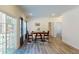 Bright dining area with wood table, chairs, blue-patterned area rug, and view of the sliding glass door to a deck at 1576 Pine Grove Rd, Ruffin, SC 29475