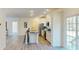 Modern kitchen with stainless steel appliances, granite countertops, island with seating, and view to the deck at 1576 Pine Grove Rd, Ruffin, SC 29475
