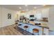 Eat-in kitchen island features modern appliances, granite countertops, and four stools for a welcoming space at 1576 Pine Grove Rd, Ruffin, SC 29475