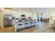 Modern kitchen boasts a large island with seating, white cabinetry, granite countertops, and stainless steel appliances at 1576 Pine Grove Rd, Ruffin, SC 29475