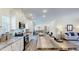 Gourmet kitchen with white cabinetry, stainless appliances, expansive island for dining, and view to the living room at 1576 Pine Grove Rd, Ruffin, SC 29475
