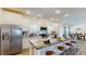 Gourmet kitchen with an island, granite countertops, white cabinets, and stainless appliances, leading to a dining area at 1576 Pine Grove Rd, Ruffin, SC 29475