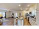 Kitchen boasts an island with seating, granite countertops, white cabinets, and an open layout to the living area at 1576 Pine Grove Rd, Ruffin, SC 29475