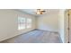 Spacious primary bedroom with soft carpet flooring and plenty of sunlight from the windows at 1576 Pine Grove Rd, Ruffin, SC 29475