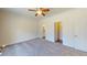 Spacious primary bedroom with soft carpet flooring, ensuite bath, and a walk-in closet at 1576 Pine Grove Rd, Ruffin, SC 29475