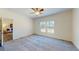Spacious primary bedroom with soft carpet flooring and plenty of sunlight from the windows at 1576 Pine Grove Rd, Ruffin, SC 29475